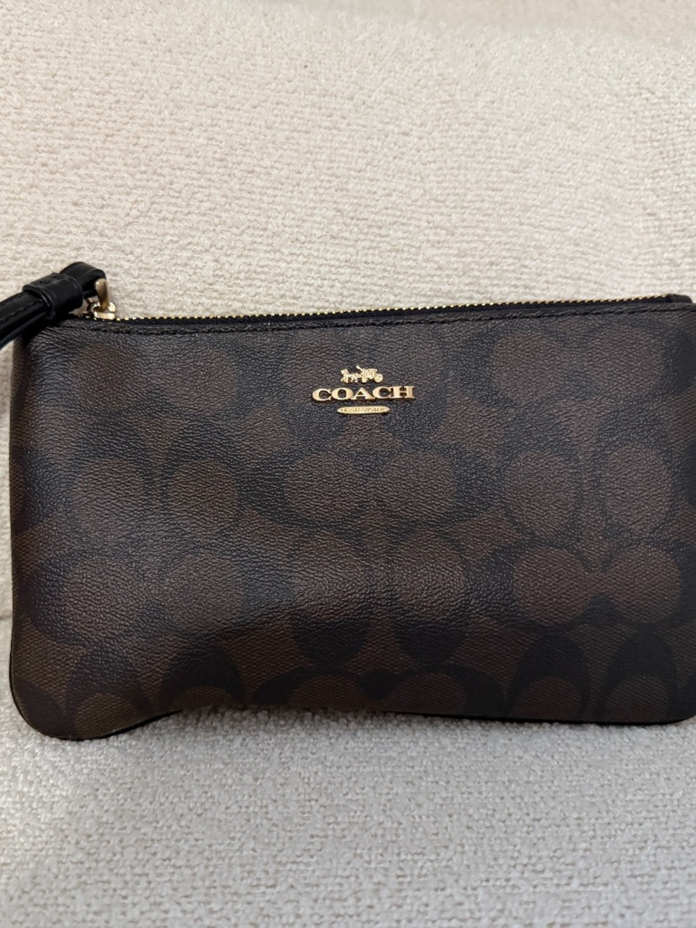 Coach wristlet in Signature canvas